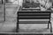 Black and white photo with empty benches in the courtyard of the house during quarantine of coronavirus covid-19.