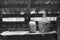 Black and white photo of glass, wooden and metallic objects in the attic