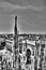 Black and white photo of marble statues of Cathedral Duomo di Milano on piazza, Milan cityscape and Galleria Vittorio Emanuele II