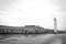 Black and white photo of an old factory of Murano glassware and lighthouse in Murano, near Venice, Veneto region, Italy
