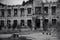 Black and white photo of old ruined by mudflow building with intricate stonework, crashed roof, empty windows