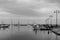 Black and white photo of the Port of Agropoli. Campania, Italy. Boats and fisherman in the water