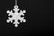 Black and white photo of safety reflector in the form snowflakes. Necessary equipment to pedestrians for walks during