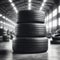 A black and white photo showcasing a pyramid stack of tires in an industrial warehouse setting.