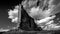 Black and White Photo of tall and fragile sandstone Rock Fin names the Tower of Babel in Arches National Park