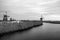 Black-white photo of windmills and water canal on sunset in Kinderdijk, Holland