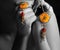 Black and white photo of a young lady hand with holding a yellow stone Flower type shaped Running Pendent Set..