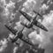 a black and white photograph of two airplanes in the sky