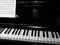 Black and white piano keyboard with offset sheet of music