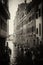 Black and white picture of gondolas near of the buildings in the Venice narrow channel