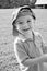 Black and white portrait of young boy wearing hat backwards