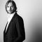 Black-white portrait of young handsome long hair man against studio background