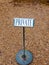 Black and white private sign post metal cobble floor