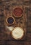 Black, white and red quinoa in spoons, raw quinoa groats assorted, wooden rustic kitchen table, top view