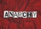 A black, white and red text collage graphic illustration on the concept of anarchy, chaos and social disorder with copy space