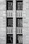 Black and white rendering of art deco building with abstract reflections in six windows - close-up