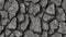 Black white rock texture. Dark gray stone granite background for design. Rough cracked mountain surface. Close-up. Crumbled.