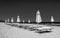 Black and white rows of umbrellas and deck chairs on the beach