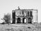 Black and white ruined house in the field