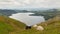 Black and white sheep with elevated view of Ullswater Lake District Cumbria England UK