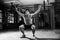 Black And White Shot Of Man In Gym Lifting Weights