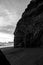 Black and white shot of a rocky outcrop on the blacksands beach in Iceland