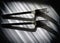 Black and white still life image with shiny chrome forks
