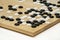 Black and White stones  of GO baduk, Weiqi game on wooden board in competition tournament