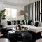 Black and white striped corner sofa and barrel chairs. Hollywood glam style interior design of modern living room