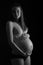 Black and white studio photography of a beautiful pregnant woman