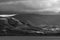 Black and white Stunning landscape image across Bassenthwaite Lake in Lake District suring moody stormy Autumn evening