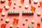 Black and white title MAGIC PILLS from white cubes on the table with tablets on coral background.