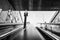 Black and white tone, interior view of stairway over handrail of escalator from underground metro station.