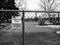 Black and white version of Closed Playground sign on a fence due to Covid 19 pandemic