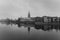 Black and white view of the Cathedral of St. John the Baptist reflected in Oder river at cold snowy day