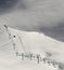 Black and white view on ski slope and chair-lift at morning