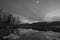 Black and white wide angle landscape view of the vast St. Croix River on a frosty winter sunset / early evening - river separating