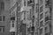 Black and white windows and balconies of a brick house