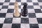 Black and white wooden kings on chessboard