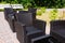 Black wicker outdoor seating area in garden.