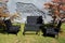 Black wicker patio furniture in the garden in front of a grey brick wall