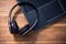 Black Wireless Overhead Headset Lying On The Corner Of A Notebook Keyboard In An Office