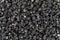 Black wolfberries or black goji berries texture as background