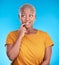 Black woman, biting nails and anxiety in studio with thinking, confused or ideas for decision by blue background