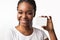 Black Woman In Braces Showing Visiting Card, White Background, Mockup