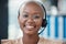 Black woman, call center and smile in portrait, consultant and glasses with headset for communication. Contact us, crm