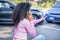 Black woman calling insurance support after car crash