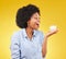 Black woman, cupcake and excited or happy in studio while eating sweet food on a yellow background. African female model
