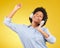 Black woman, dancing with headphones and freedom, music and happiness on yellow studio background. Happy female