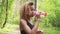 Black woman drinking from pink bottle. Portrait of black young woman taking break while jogging